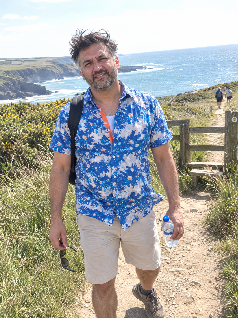 Man wearing the Aegean Bloom Short Sleeve Shirt on a coastal path