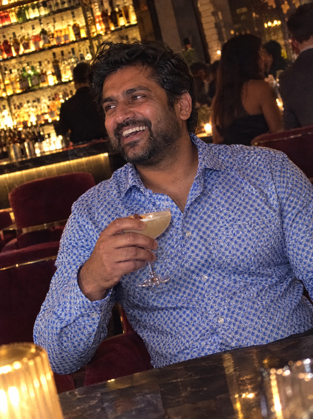 Man wearing the Blue Wavy Geo shirt in a cocktail bar