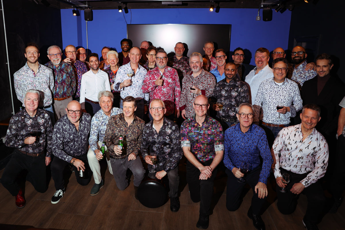 Group of guests wearing colourful patterned shirts at a Blake Mill event
