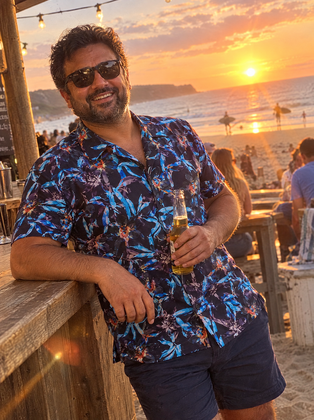 Man wearing the Electric Bamboo Short Sleeve Shirt at a beach bar