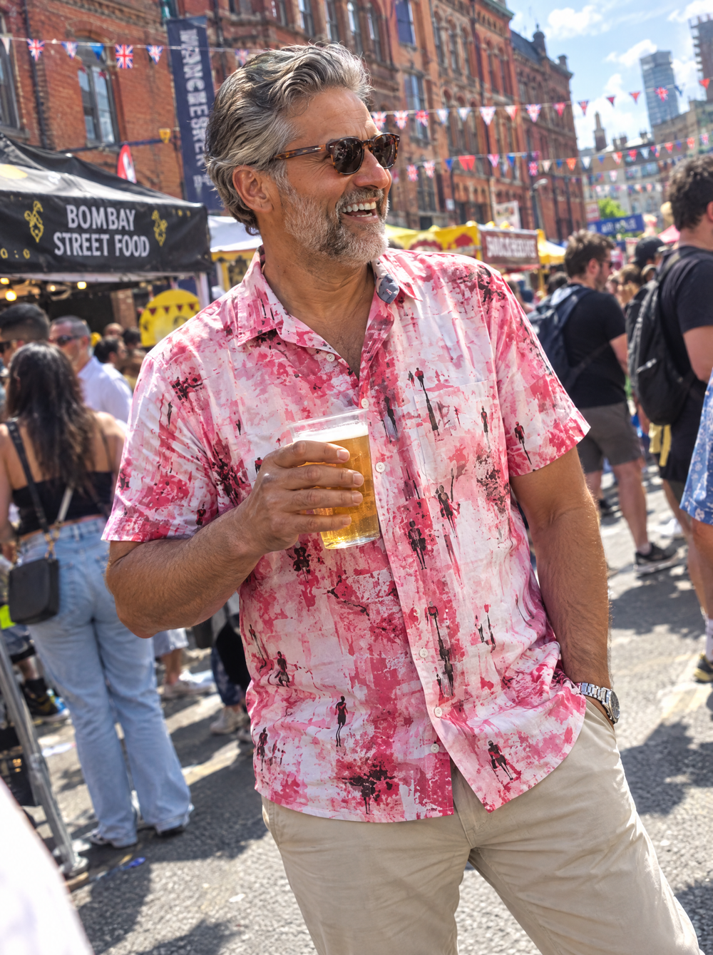 Man wearing the Manchester Dawn Short Sleeve shirt at a street festival