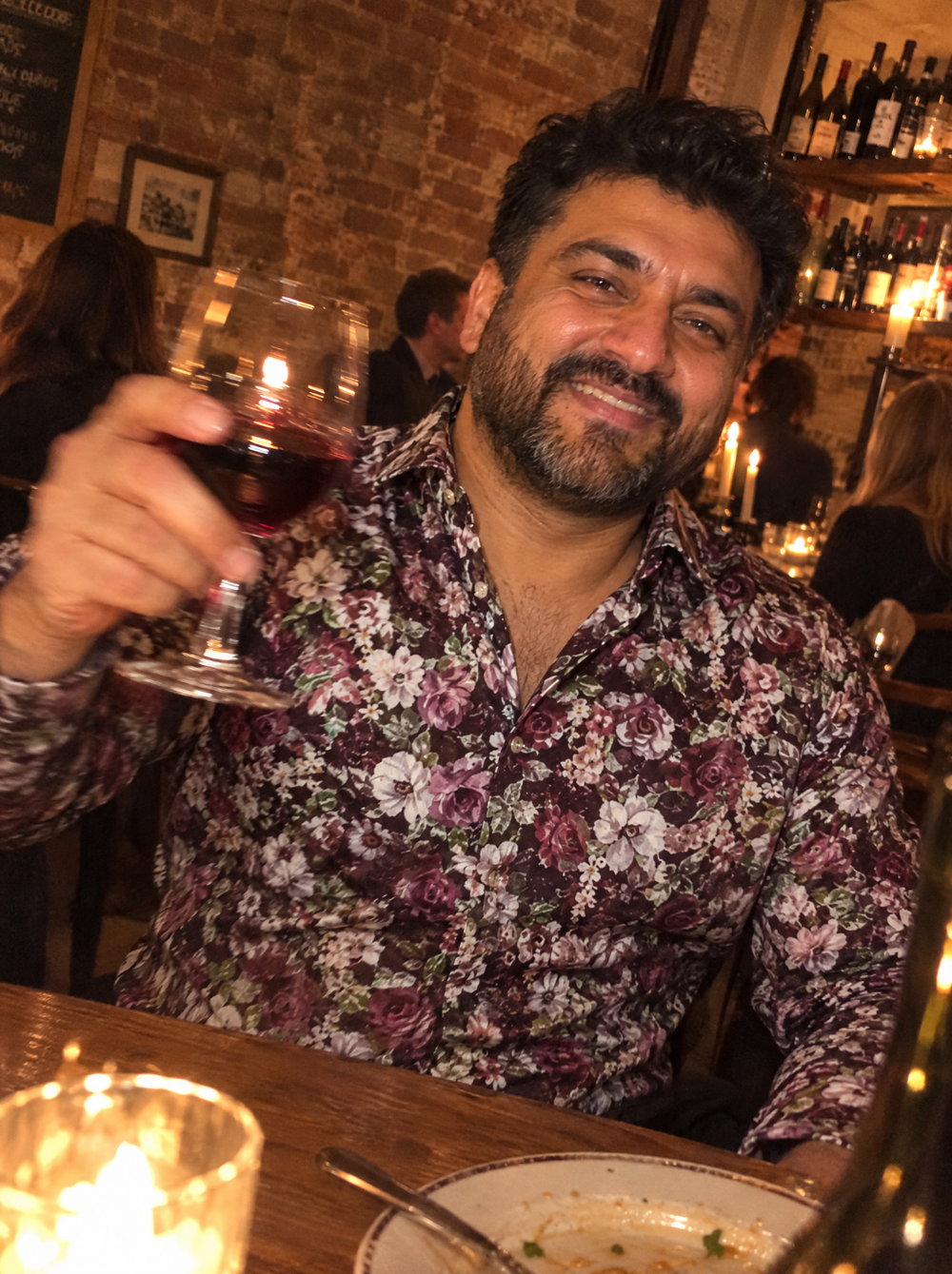 Man wearing the Name Of The Rose shirt at an Italian restaurant