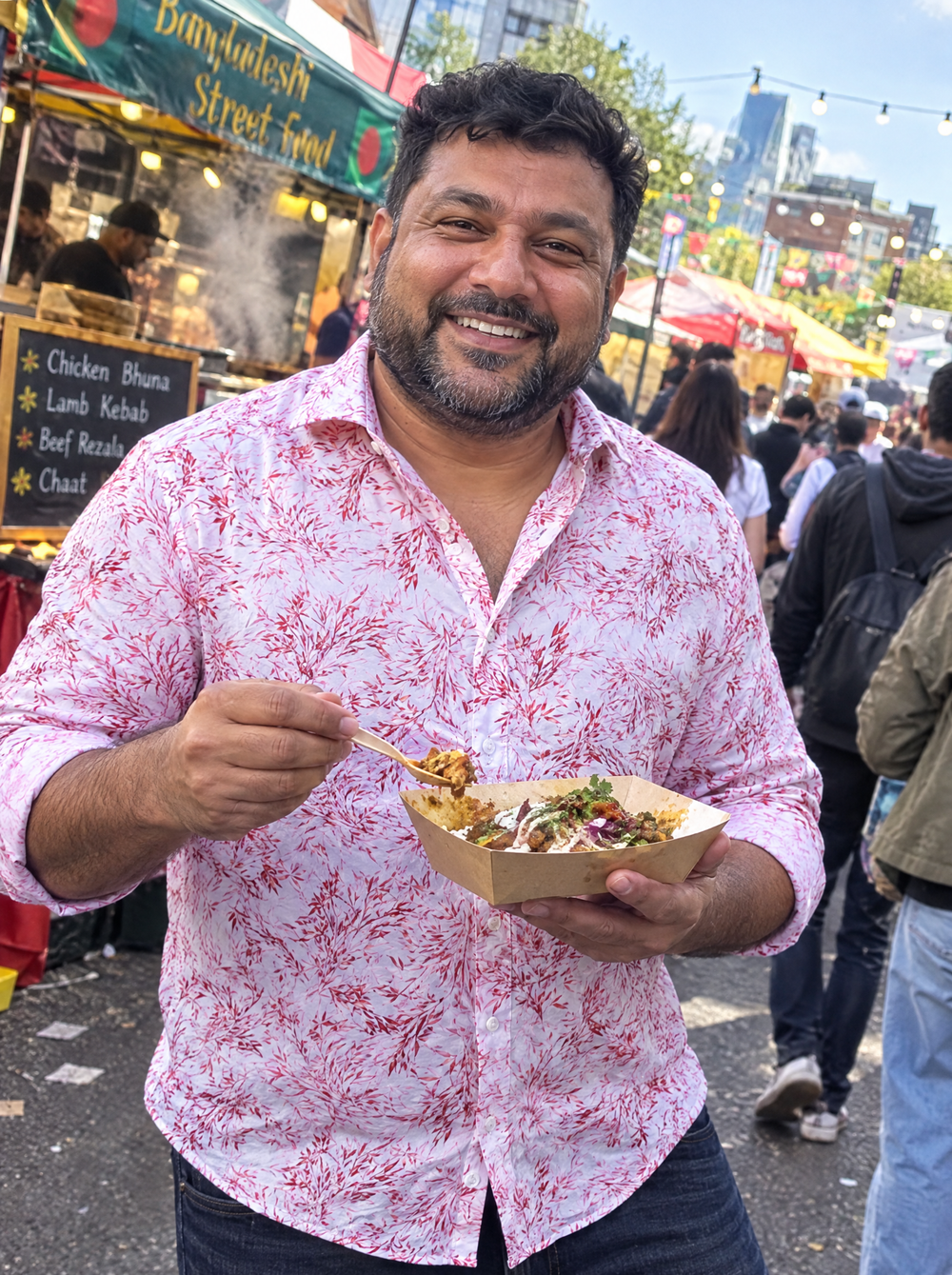 Man wearing the Pink Savanna shirt at a street-food market