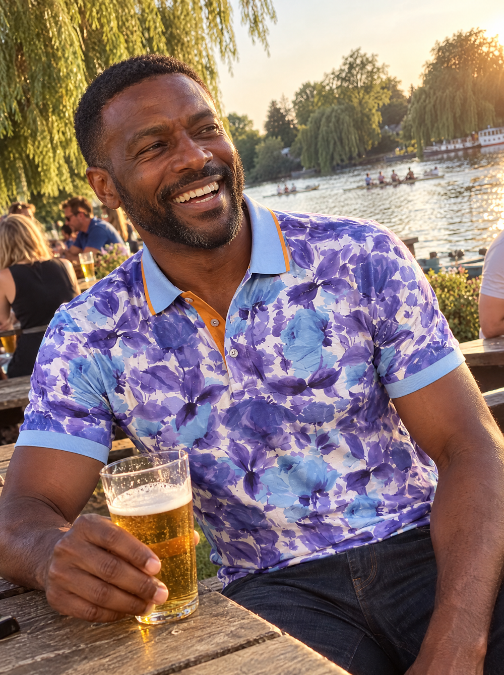 Man wearing the Summer Breeze Printed Polo in a riverside pub garden