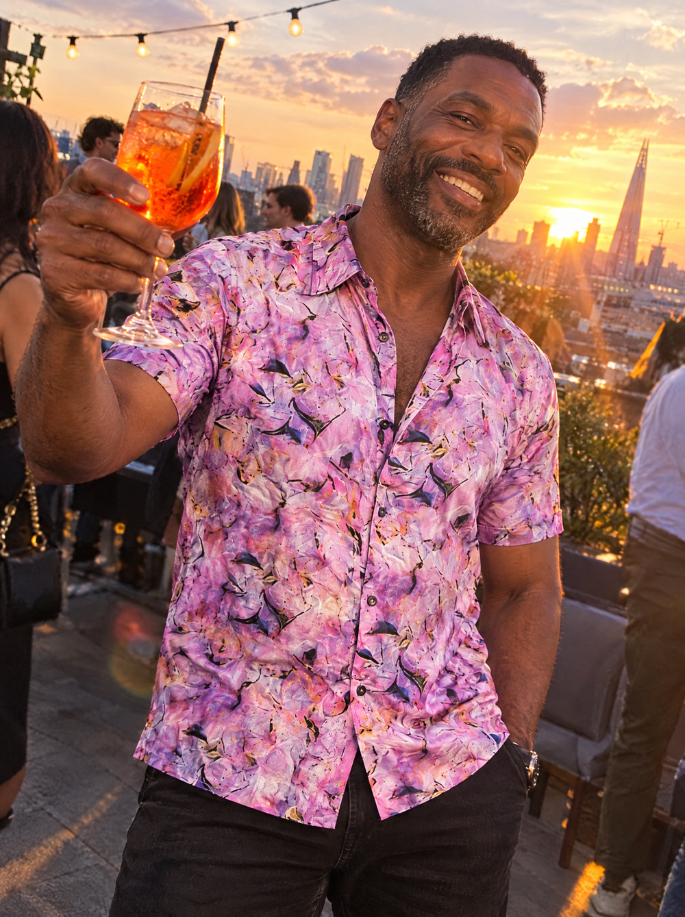 Man wearing the Violet Haze Short Sleeve shirt at a rooftop bar