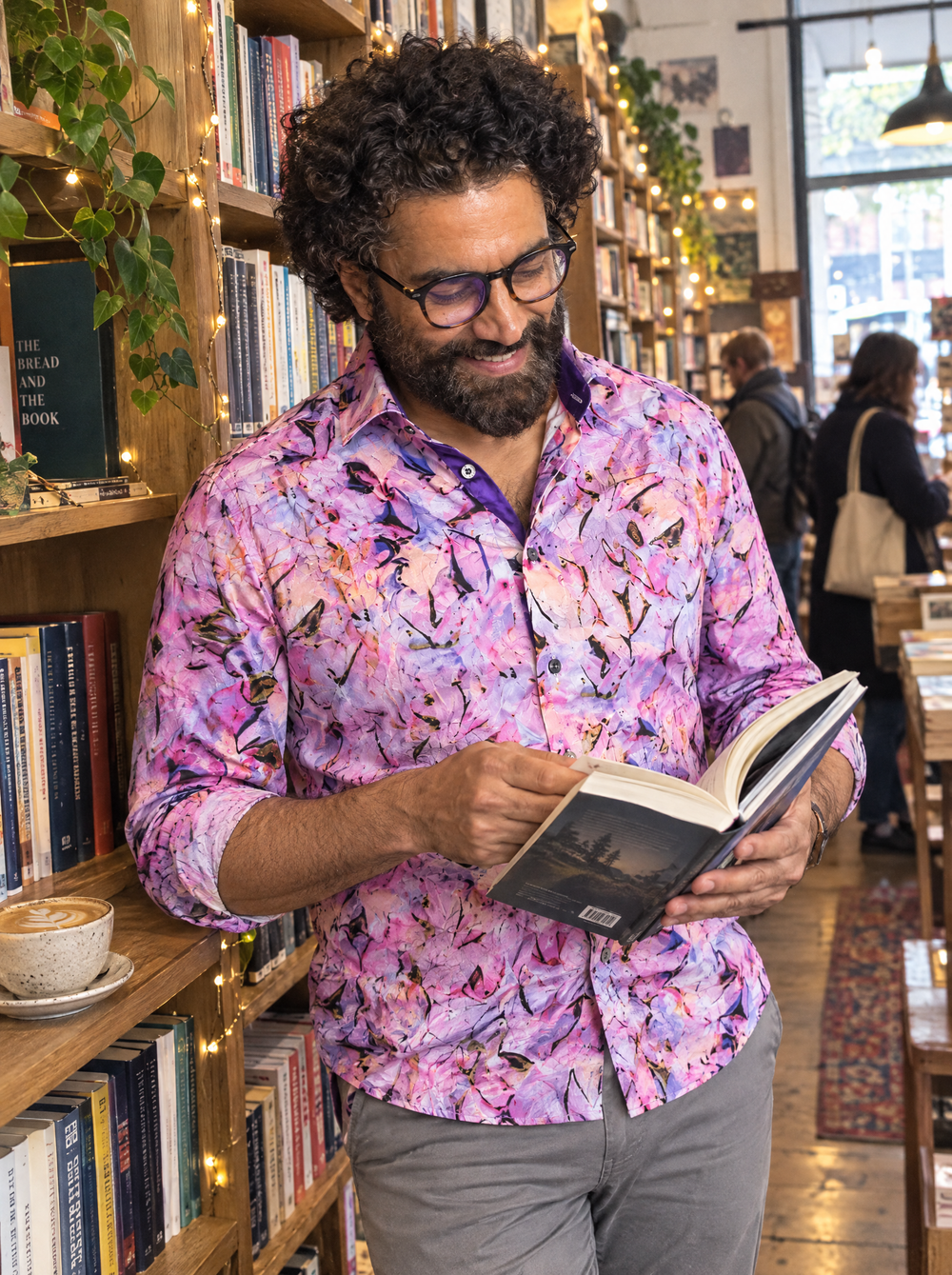 Man wearing the Violet Haze Shirt in a bookshop café