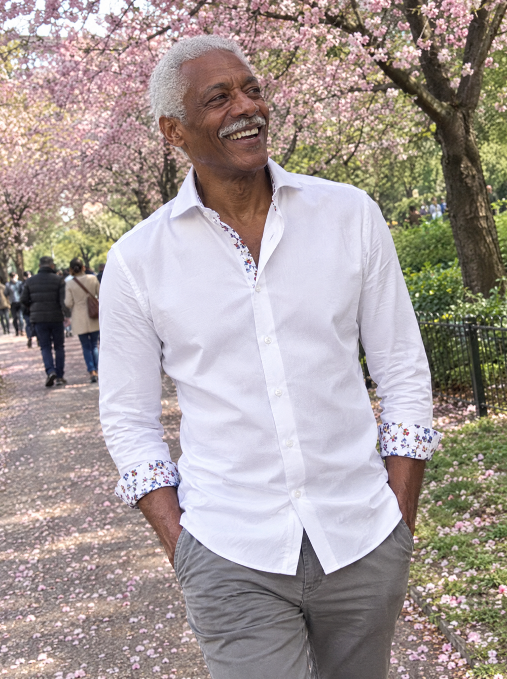 Man wearing the White Sateen Shirt with Botanical Sakura Accents under cherry blossom