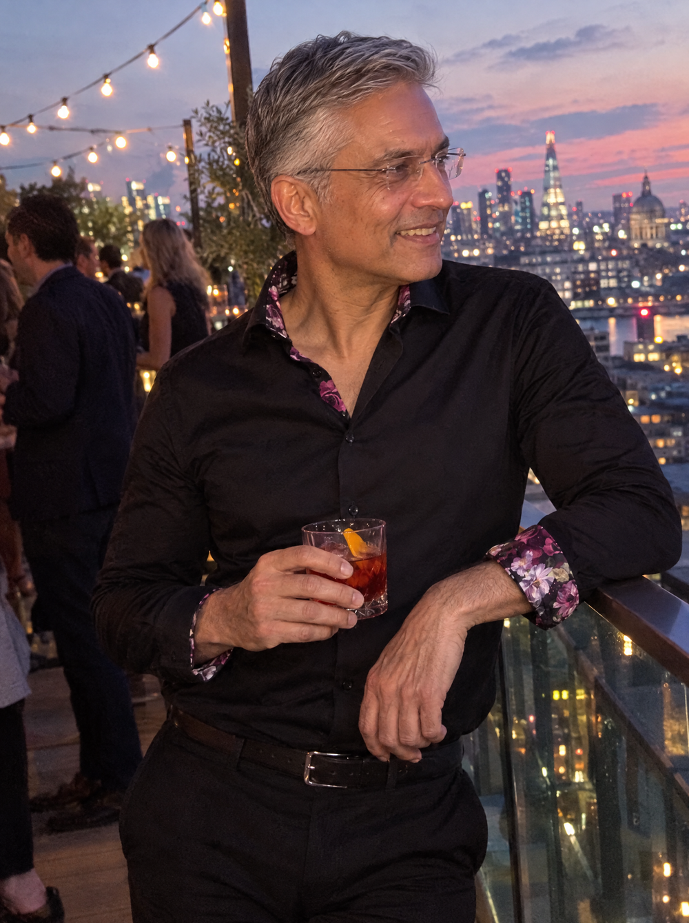 Man wearing the Black Sateen Shirt with Name of the Rose Accents at a rooftop bar