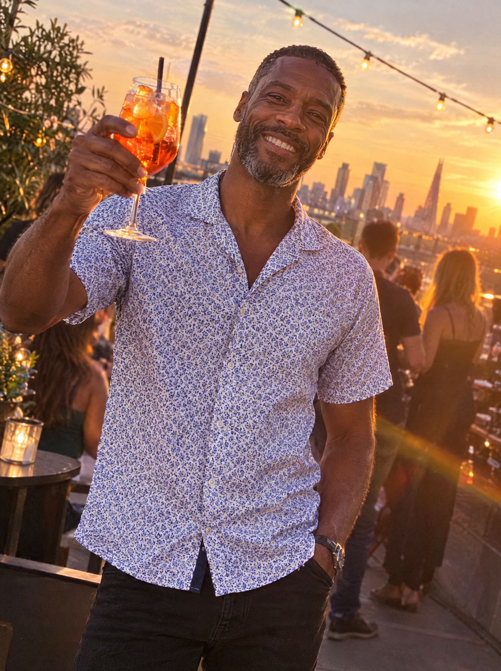 Man wearing the Blue Botanic Geo Open Collar shirt at a rooftop bar