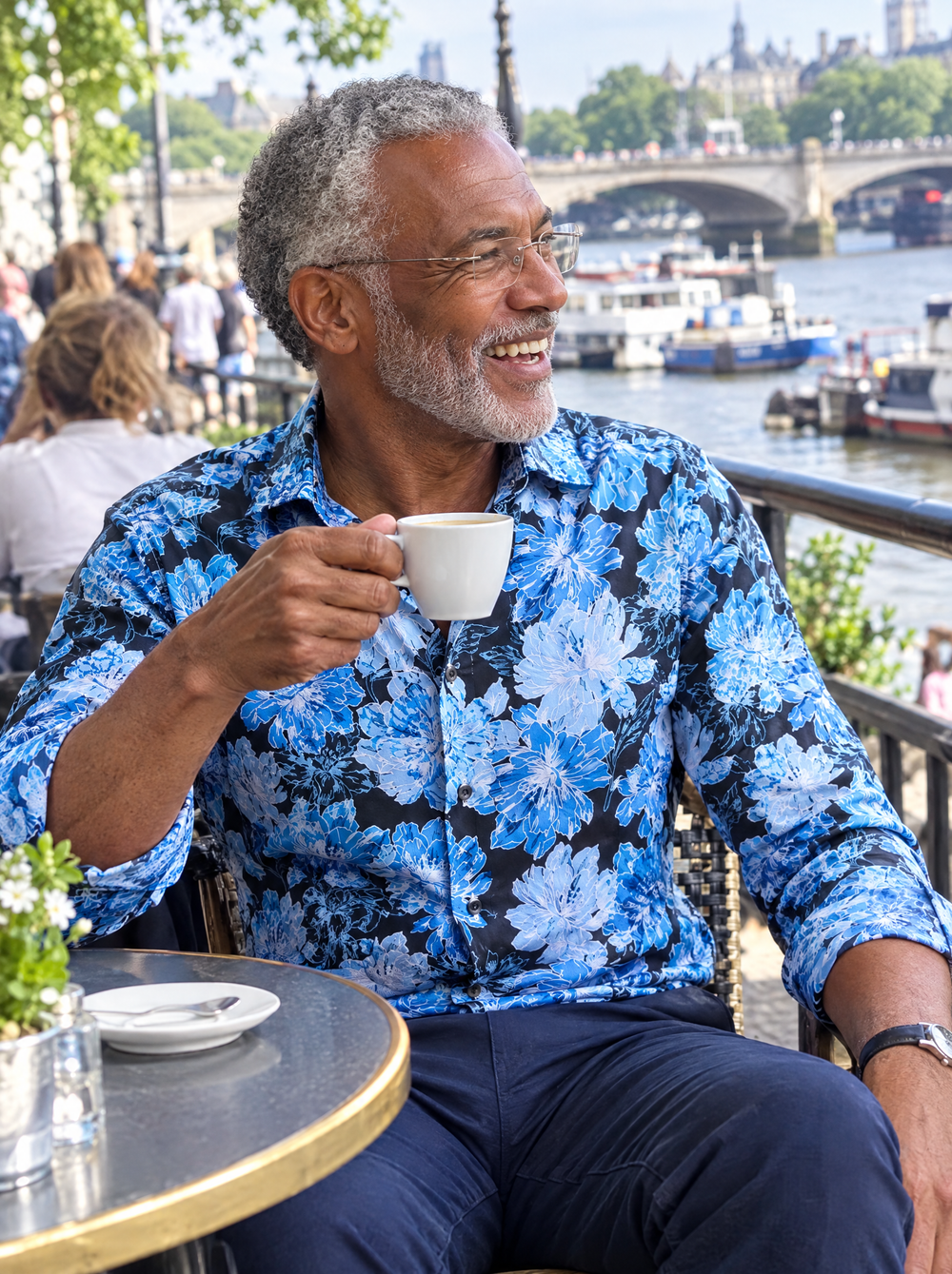 Man wearing The Blue Camellia Shirt at a riverside café