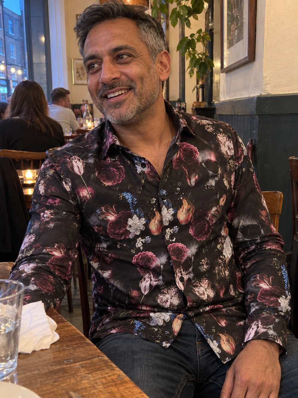 Man wearing the Dark Bloom Shirt at a restaurant table