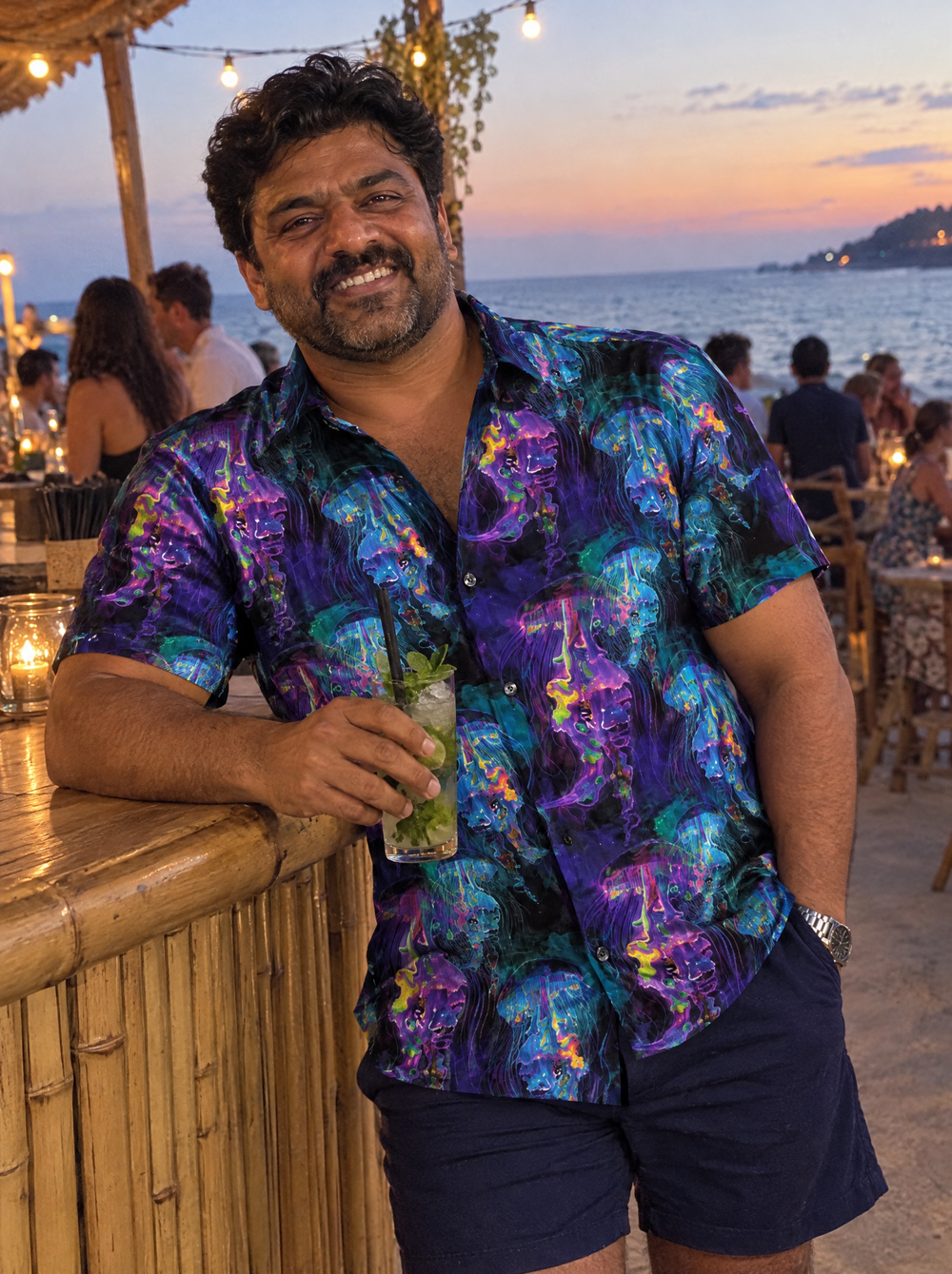 Man wearing the Electric Jellyfish Short Sleeve shirt at a seaside bar