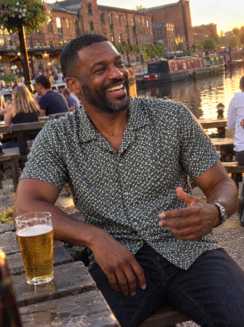 Man wearing the Green Botanic Geo Open Collar shirt at a canalside pub