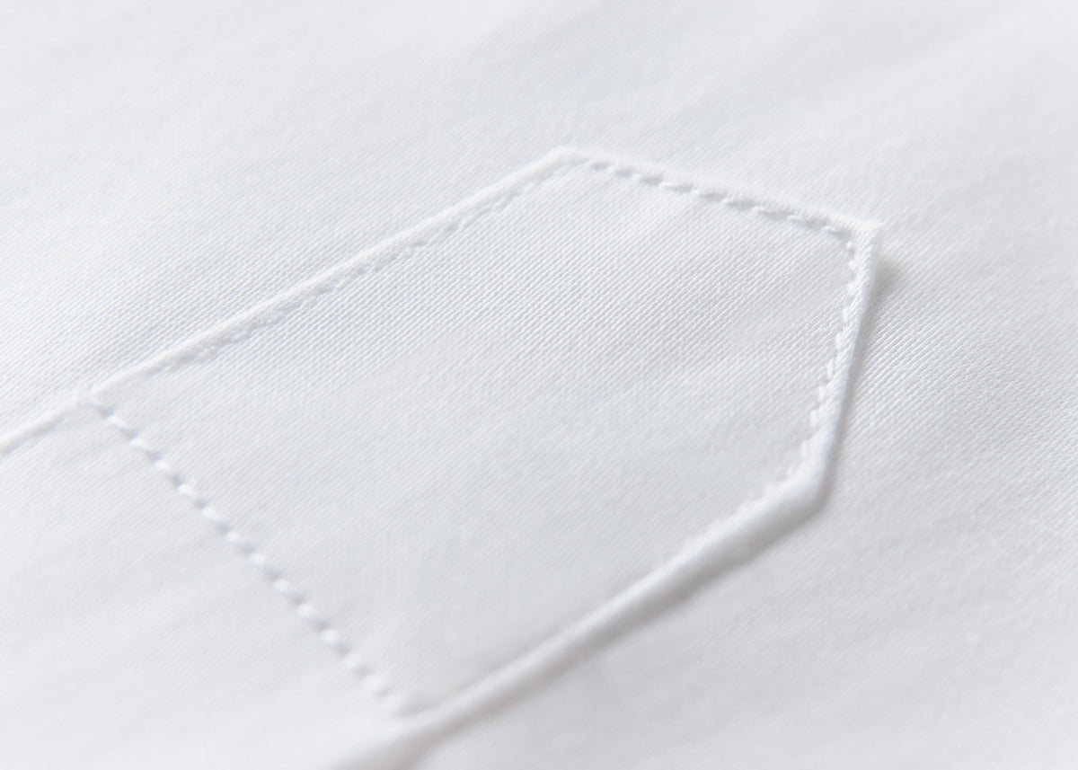 Fine stitching on white shirt fabric