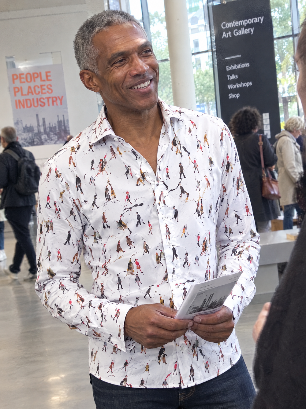 Man wearing the Lowry: Going To Work Shirt in an arts centre foyer
