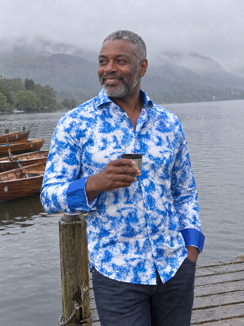 Man wearing the Mistwave shirt on a misty lake jetty