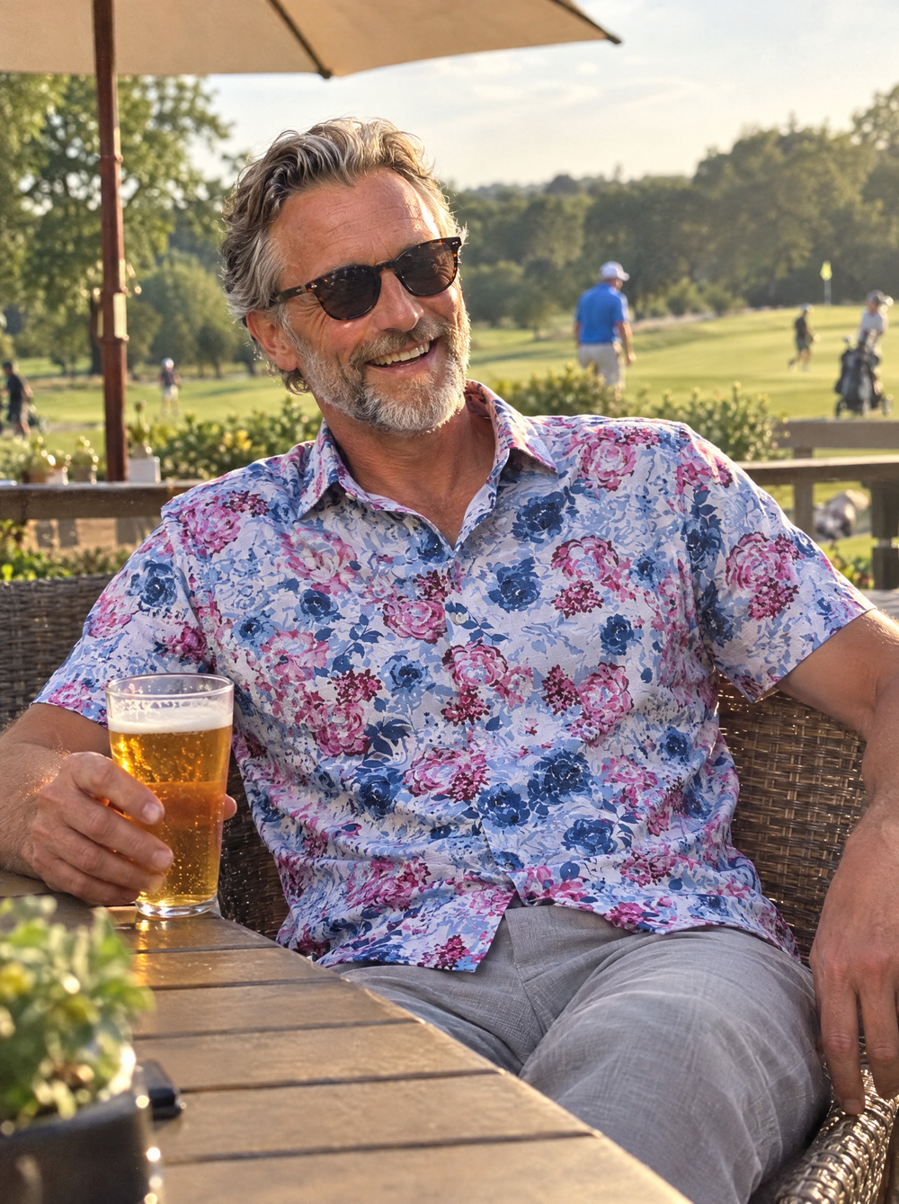 Man wearing The Roseate Linen Short Sleeve shirt on a golf clubhouse terrace