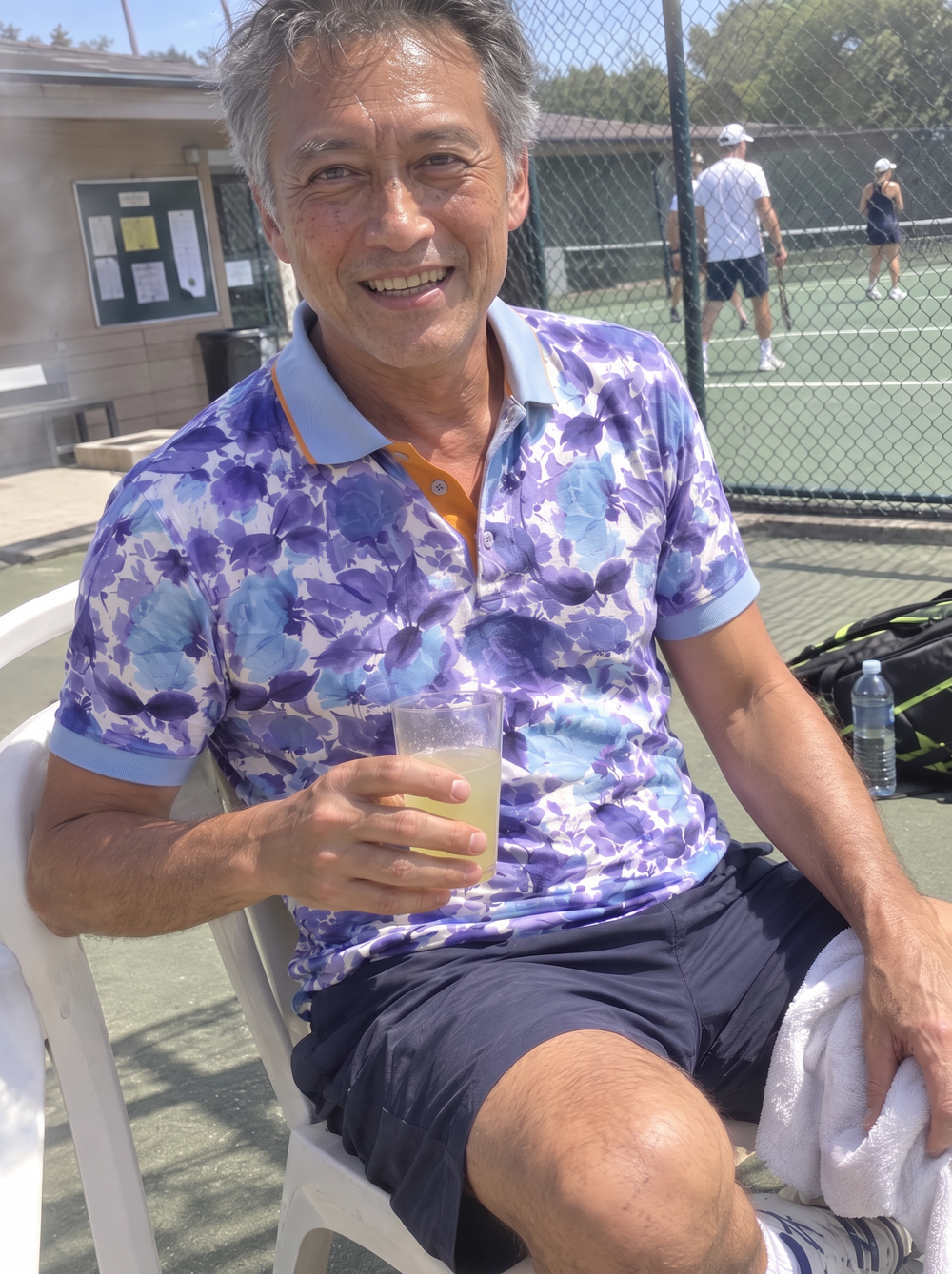 Man wearing the Summer Breeze Printed Polo at a tennis club