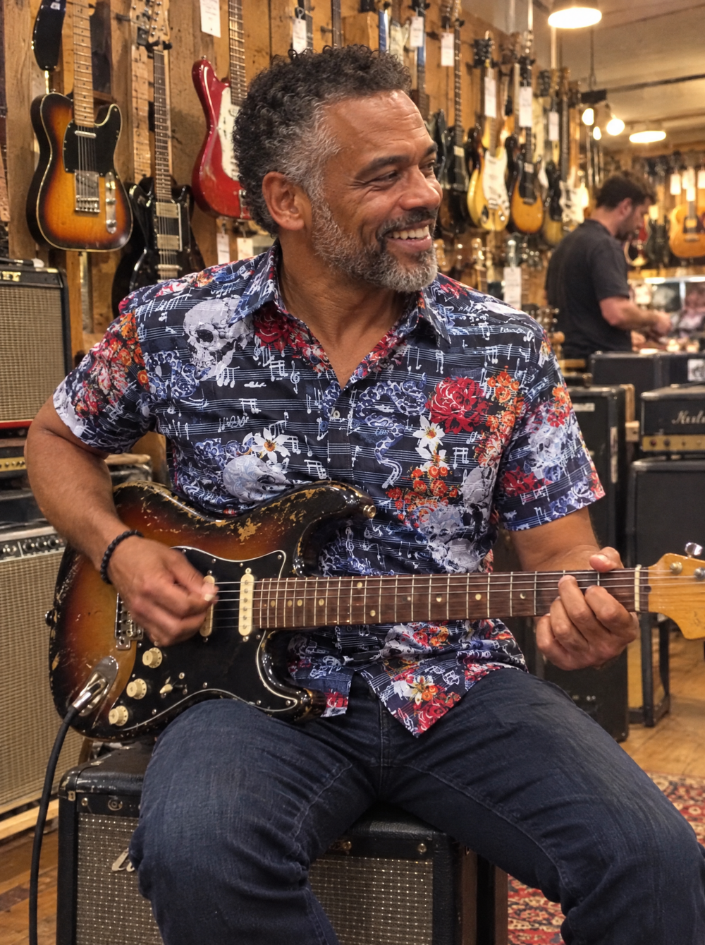 Man wearing the Vanitas Sonata (Navy) Short Sleeve Shirt in a guitar shop