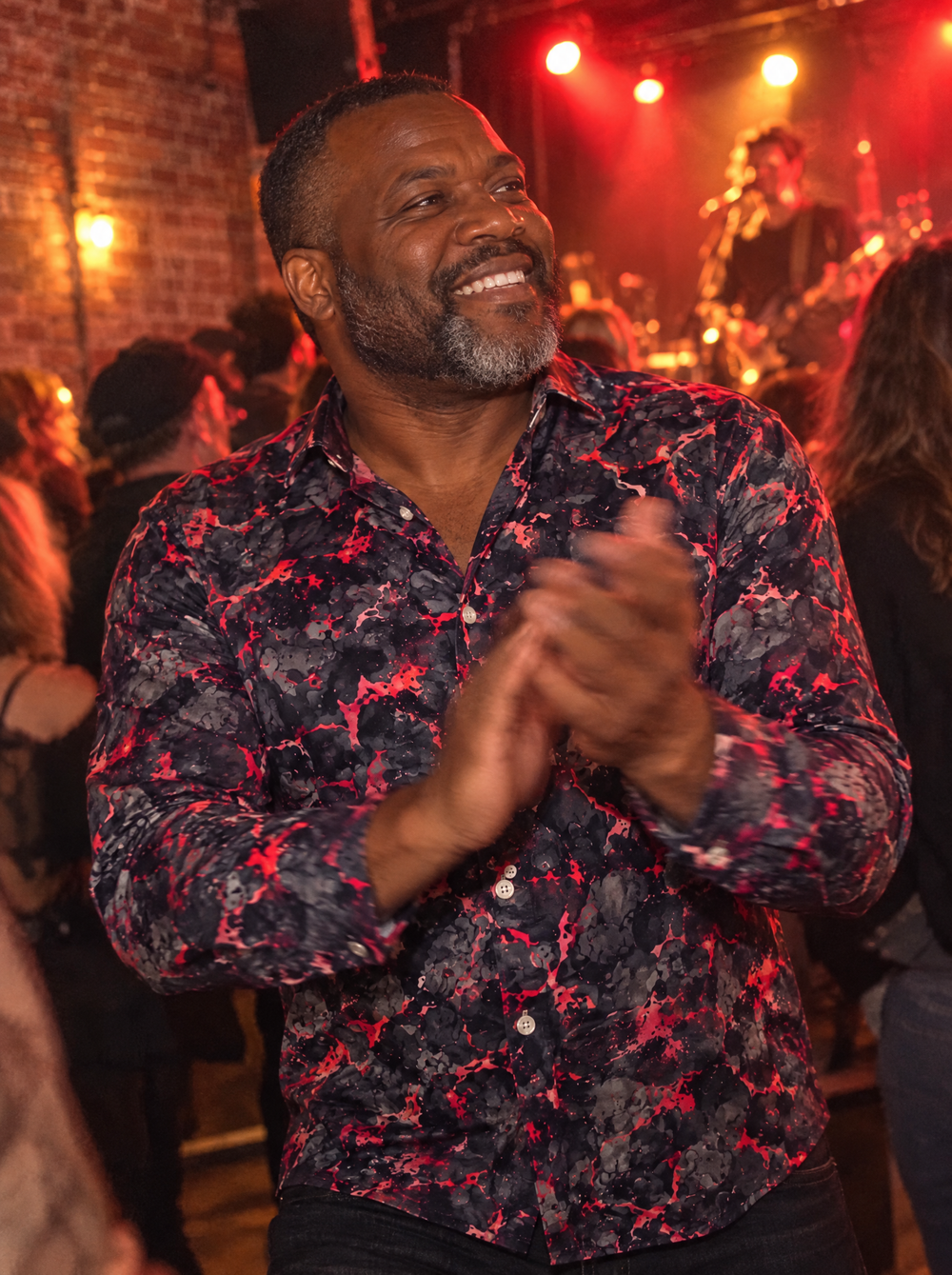 Man wearing the Volcano (Red) shirt at a live music venue