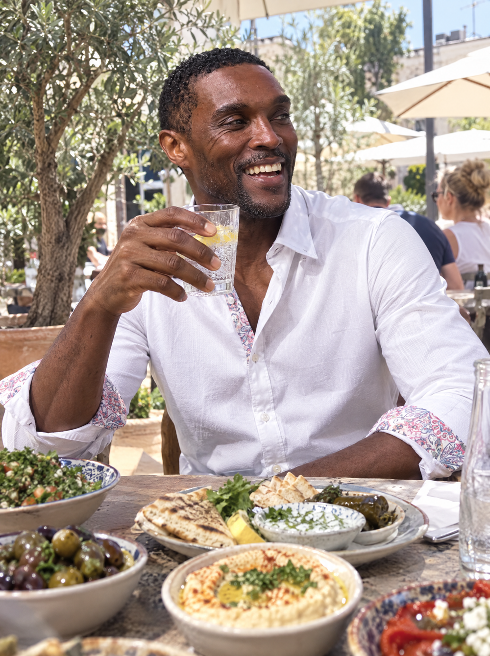 Man wearing the White Textured shirt with Persian Paisley Accents at a terrace lunch