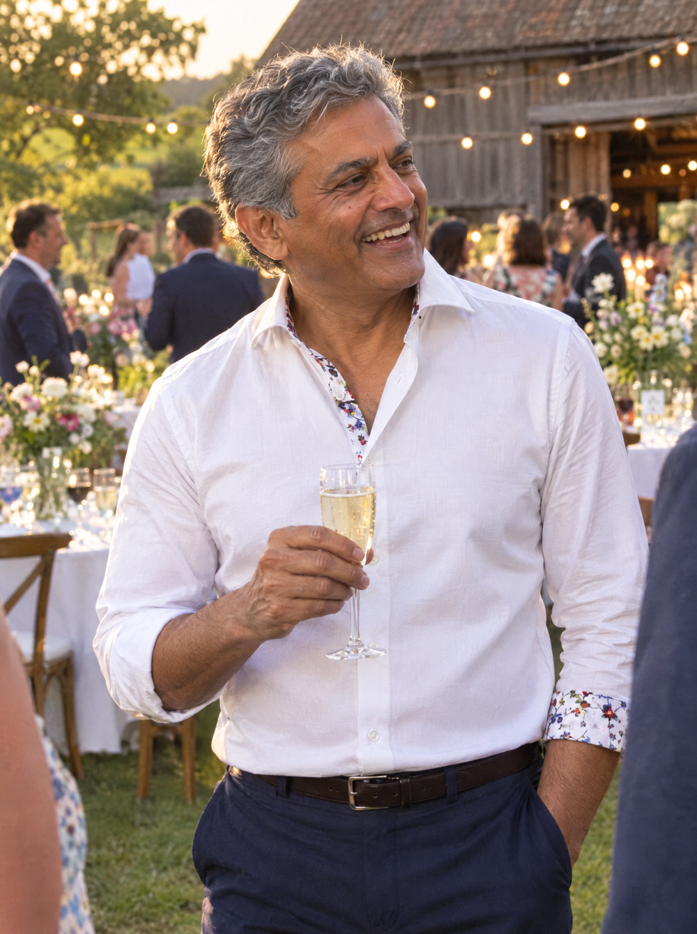 Man wearing the White Sateen Shirt with Botanical Sakura Accents at a wedding reception